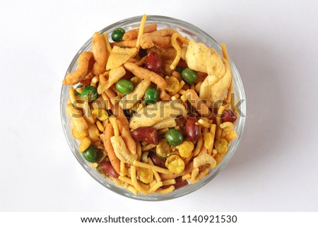 Delicious and crunchy Mix Nimco in golden antique bowl, Top shot of nimko, Traditional refreshment for tea time or evening brunch. Royalty-Free Stock Photo #1140921530