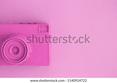 Vintage camera on background in pastel pink color minimal creative art concept. Space for copy.