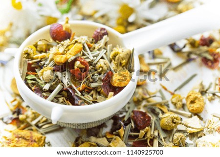 Dry flower tea leaves on a white background in a composition on a table