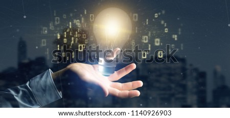 View of a Businessman holding a bulb lamp idea concept with data all around 3d rendering
