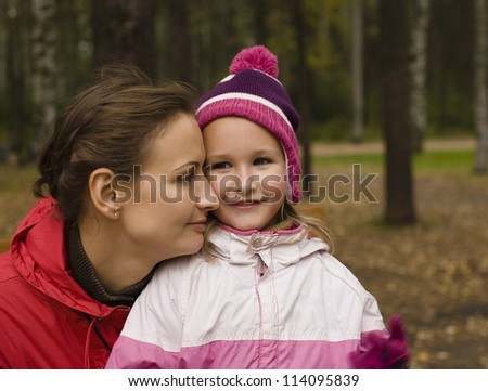 portrait of happy family mother with daughter in park