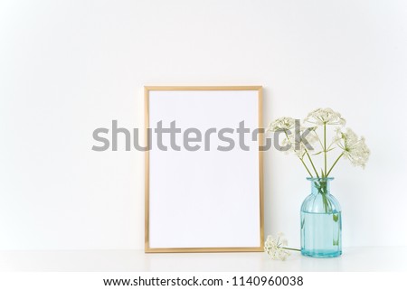 Gold frame mock up with a wild host in blue vase. Mockup for , promotion, design. Template for small businesses,bloggers