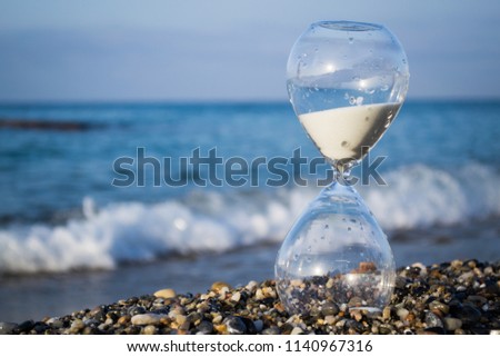 Hourglass on the beach, on the Mediterranean coast