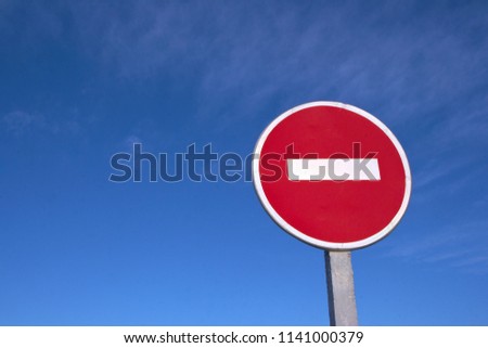 Road stop sign against clear deep blue sky