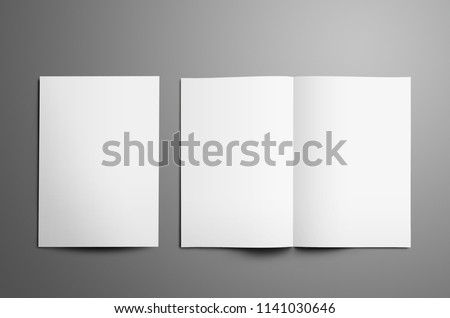Universal tempalte with two white  A4, (A5) bi-fold brochures with realistic  shadows isolated on gray background. One booklet is closed the second is open on the spread.  Top of view.  Royalty-Free Stock Photo #1141030646