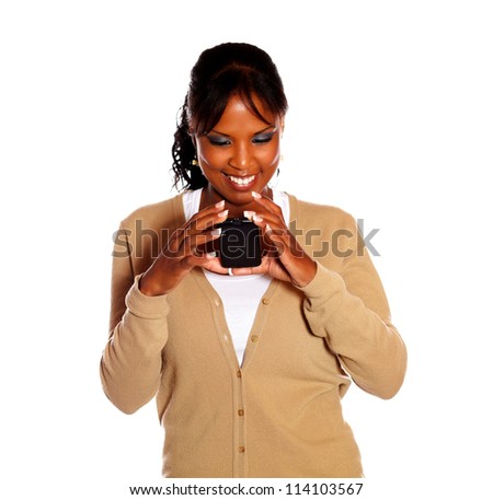 Afro-american woman reading message on cellphone against white background