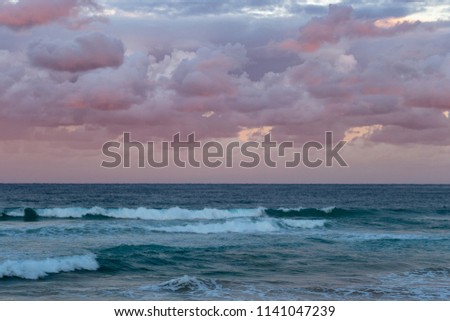 Beautiful sunset at the beach pink and blue colors