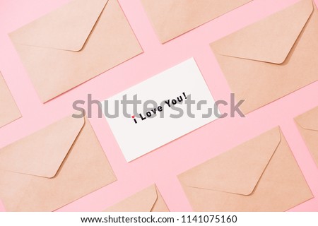 Frame from envelopes and postcard on pink table top view. Words I LOVE You. Valentine concept. Flat lay. Royalty-Free Stock Photo #1141075160
