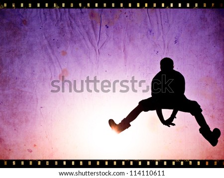 silhouette of man on the sunset on film strip background