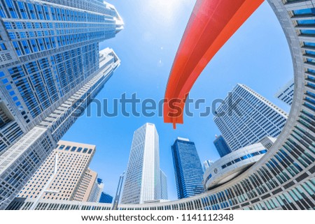 Asia Business concept for real estate and corporate construction - looking up view of panoramic modern city skyline with blue sky in shinjuku, tokyo, japan