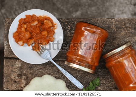 bush pumpkin in tomato sauce (a portion food) - conservation of products. food background
