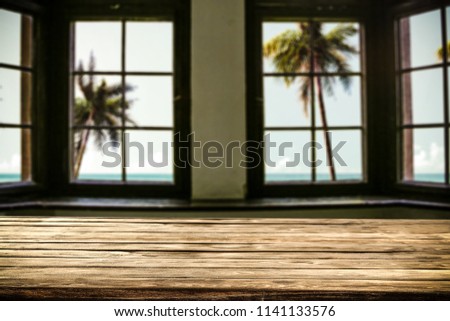 Table background of free space and window with summer landscape with palms. 