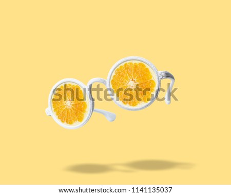 White sunglasses with orange on bright background. Summer minimal concept. Royalty-Free Stock Photo #1141135037
