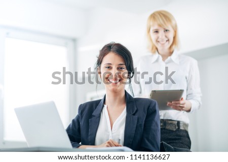 Two women business partners collaborate at the office