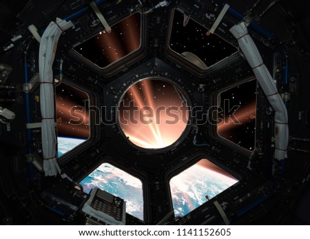 Earth in window of spaceship. Elements of this image furnished by NASA.

