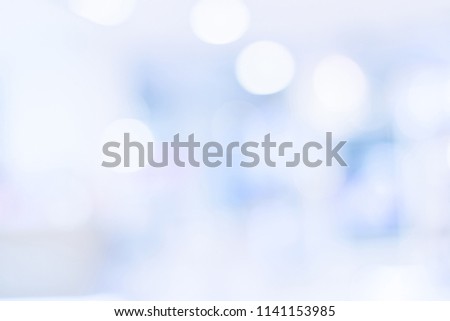 Perspective blur background image of hallway in shopping mall or department store with bokeh and people background usage concept.