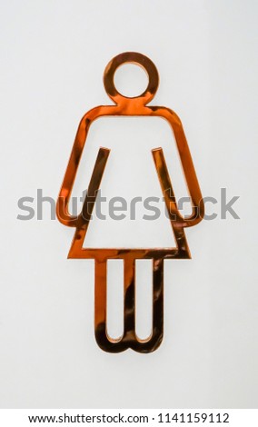 Public restroom signs with female symbol made of copper on white background