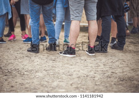 Teenagers at summer festival feet background