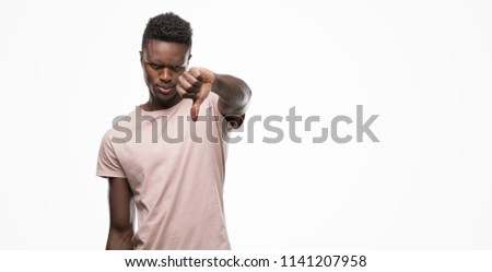 Young african american man with angry face, negative sign showing dislike with thumbs down, rejection concept