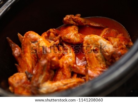 Red hot wings for a cook off Royalty-Free Stock Photo #1141208060