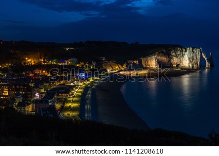 Picturesque landscape on the chalk cliffs of Etretat after the sunset. The needle rock and the stone arch. Etretat, Normandy, France