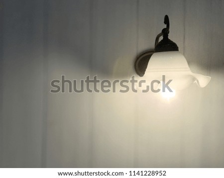 Vintage lamp decoration on wooden white wall, copy space