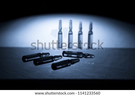 Group object of liquid medicinal agent in limpid glassware in medical laboratory. Ampoules with cosmetical tools, collagen or vitamins