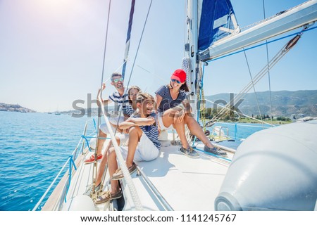 Happy family with adorable daughter and son resting on a big yacht Royalty-Free Stock Photo #1141245767
