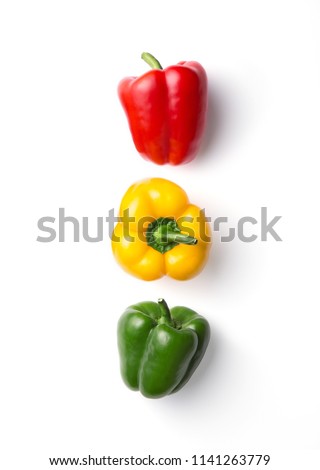 Variation of different color bell peppers on a white background. Colorful paprikas viewed from above isolated on white. Top view. Semaphore or traffic light concept. Royalty-Free Stock Photo #1141263779