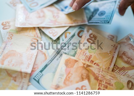 money background with american dollars and turkish liras, hundred dollars and fifty turkish liras background. random moneys, economic and financial crisis