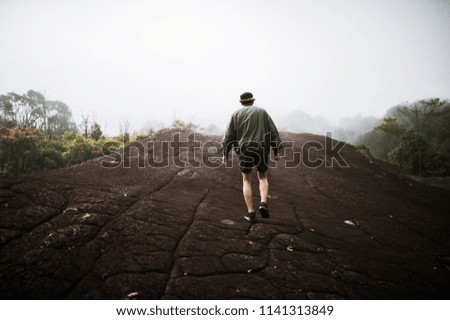 man hike on the peak of rocks mountain