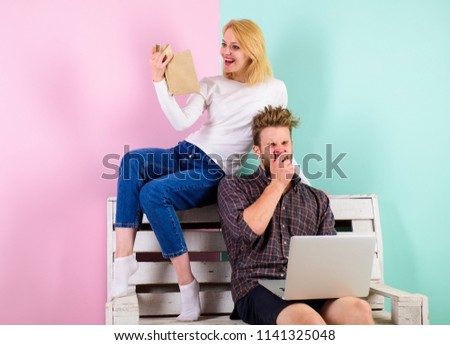 Focus of interest. Girl and guy interested in intellectual activity. Man with laptop and woman with book enthusiastic intellectual activity. Couple with different interests spend time together.