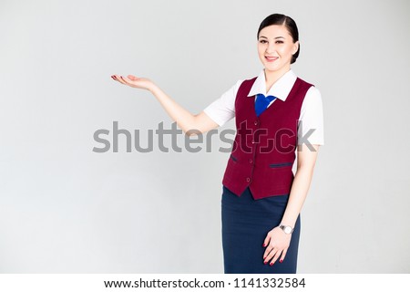 Stewardess in red uniform gestures with her hands
