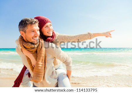 happy autumn fall couple showing with outstretched arms