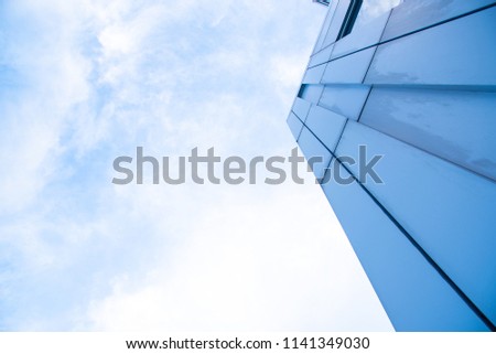 Abstract of office building window close up with sky reflection background. Detail glass building with the blue sky as concept for saving the earth.