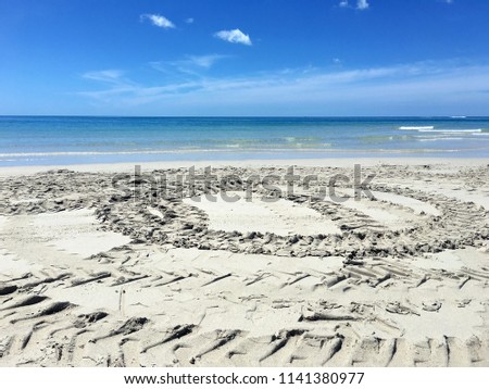 The circle wheel print on the sand beach and the beautiful sea view