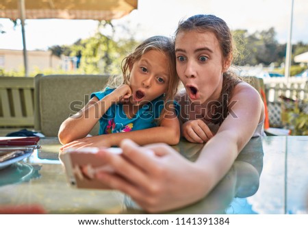 girls at the table taking selfies