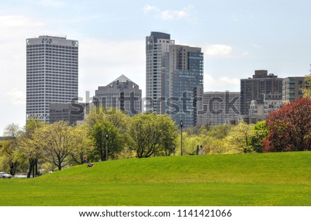 Springtime view of downtown Milwaukee  from the green grass of Juneau Park.