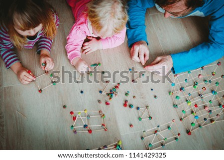 teacher and kids making geometric shapes