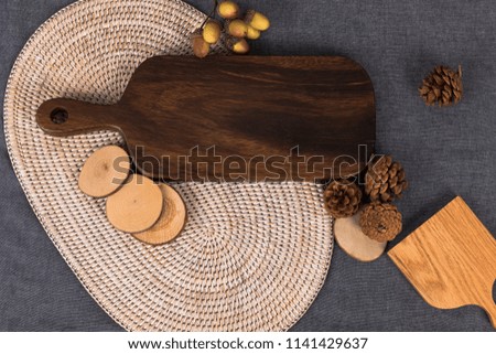 A wooden table with autumn feeling and a table with fruit. A well-being meal preparation on a tablecloth of gray color, a photo image of a chopping board picture usable as a dining table menu.