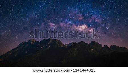 Nature landscape view of mountain range with universe space of milky way galaxy and stars on night sky