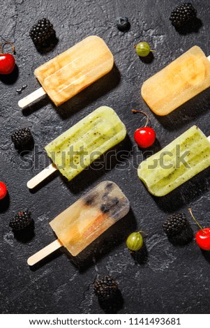 Photo of ice cream on stick, blackberry ,cherry, gooseberry