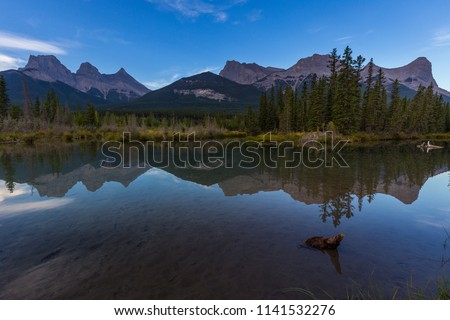 Sunrise view of Policeman's Creek along the Bow River outside Canmore, Alberta. Mount Lawrence Grassi with Ha Ling Peak on the far right of Mount Grassi.