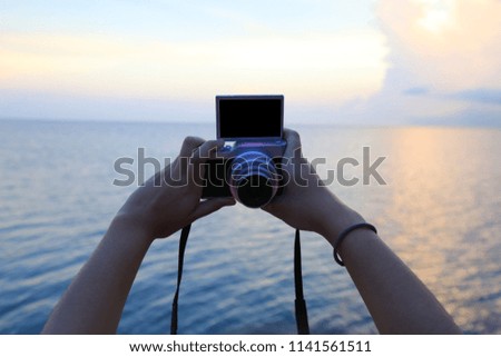 Selfie by camera at the sea background ocean and sunset.