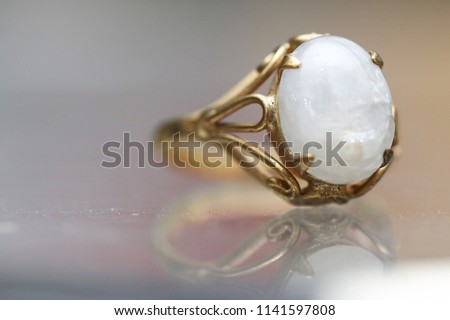 Opal white gem stone on gold ring