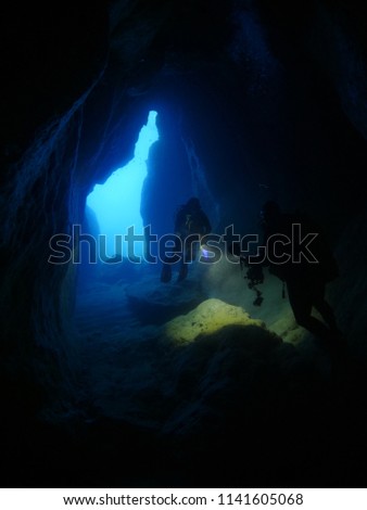 underwater photographer taking photos underwater scenery in caves and tunnels