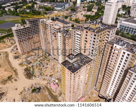 urban civil construction site with cranes. birds eye view. aerial photography
