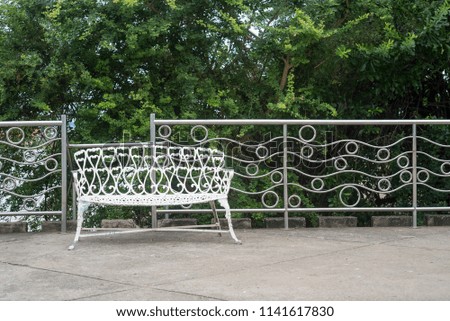White metal park bench in the park