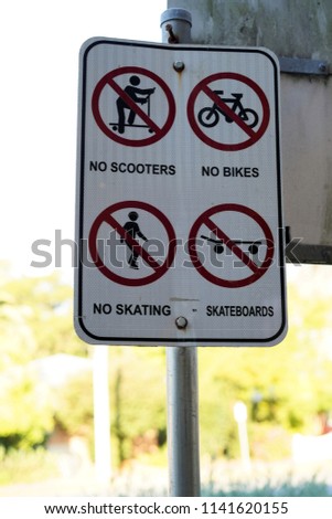 Sign post says no scooters, no bikes, no skating, no skateboards on footpath in Australia                              