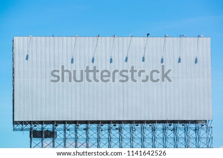 Billboard with clouds and blue sky. The concept of outdoor advertising.